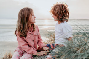 boy and girl on beach by family photographer Hester Barnes