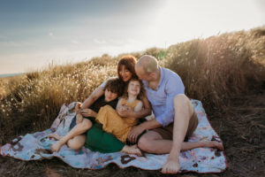 hester barnes and her family on beach by Surrey family Photographer